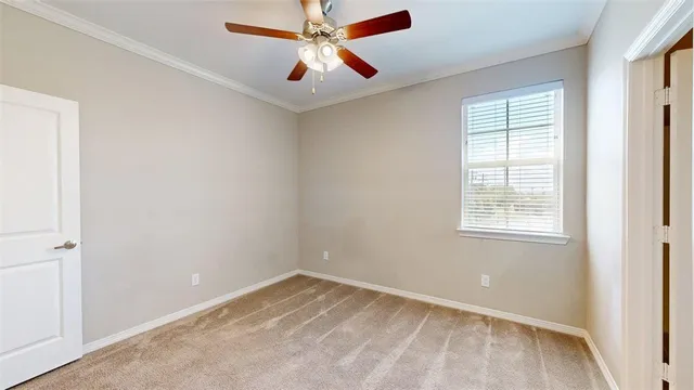 a view of an empty room with a ceiling fan