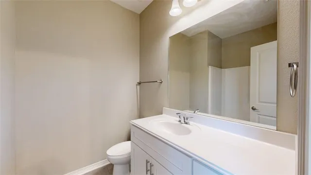 a spacious bathroom with a granite countertop sink a mirror and shower