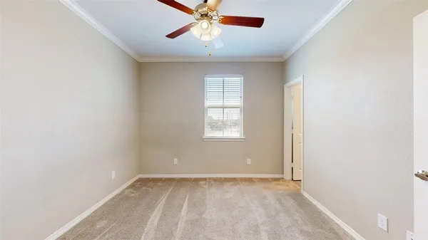 a view of a livingroom with a ceiling fan and a bathroom