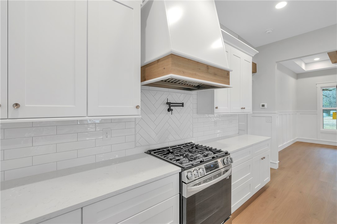 4554 Flat Rock Road Iva, SC 29655 - Photo 13 of 32 Culinary aspirations meet sleek design in this well-appointed kitchen featuring a modern gas range.