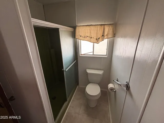 a bathroom with a toilet and a shower