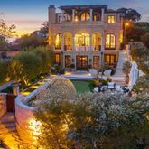 a view of a brick building with large tree and windows