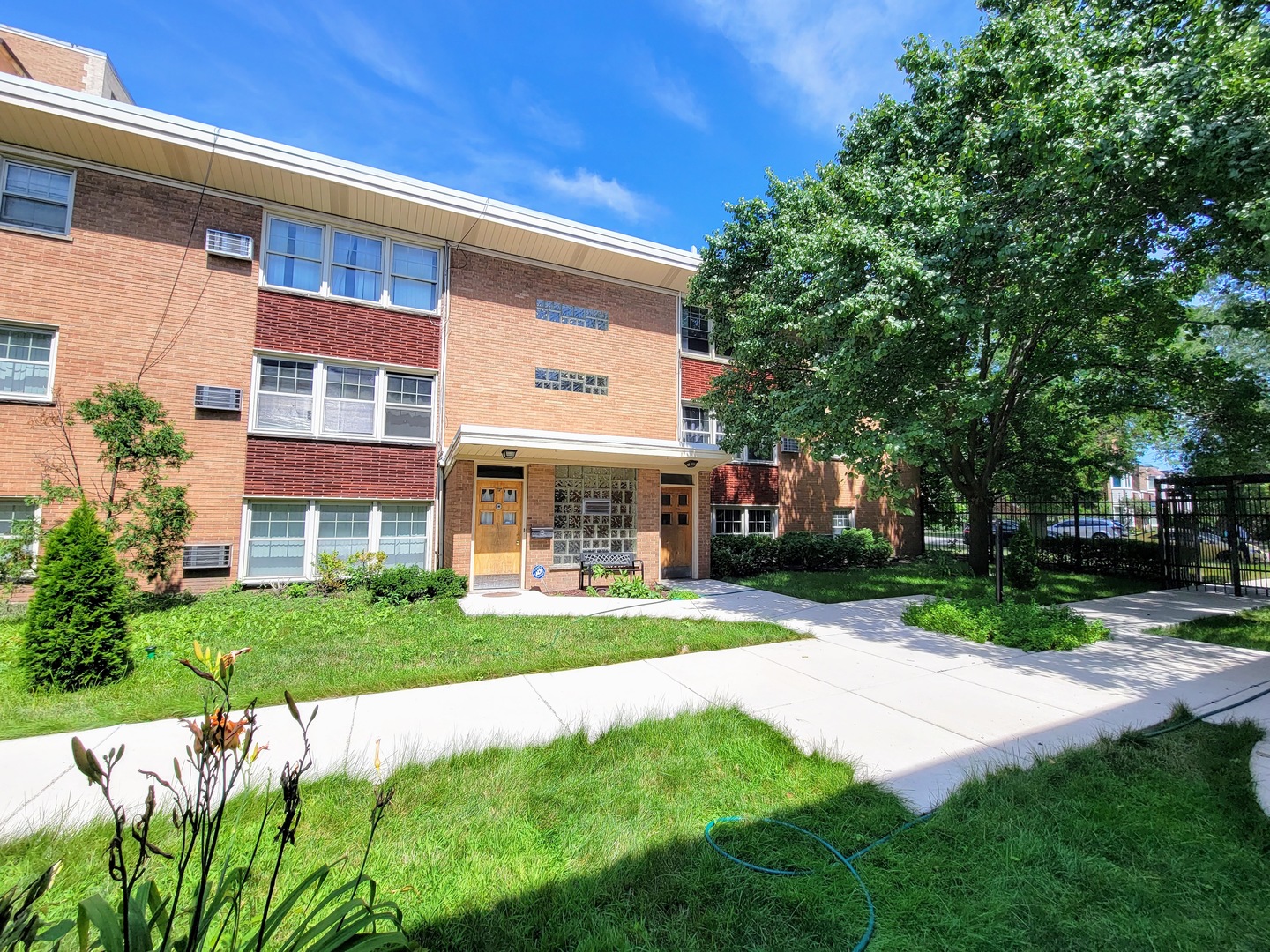 7538 North Ridge Boulevard, Unit 3E Chicago, IL 60645 - Photo 1 of 20 a view of a building with a yard
