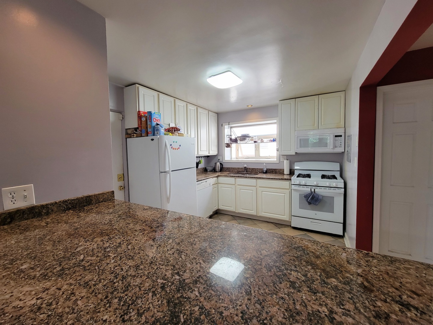 7538 North Ridge Boulevard, Unit 3E Chicago, IL 60645 - Photo 10 of 20 a kitchen with white cabinets and white appliances