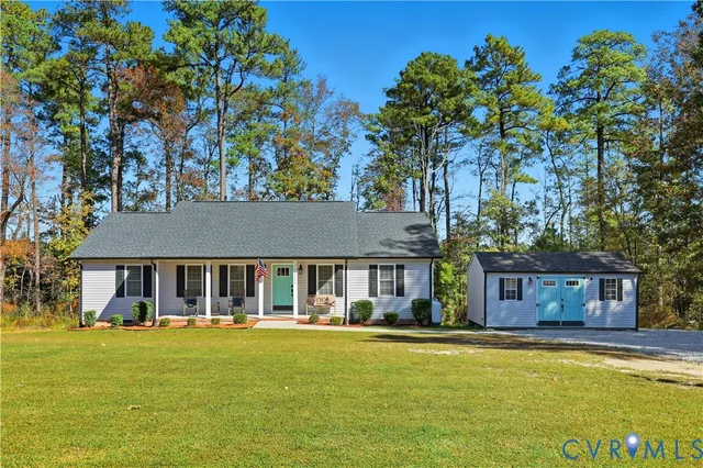 a front view of a house with swimming pool having outdoor seating