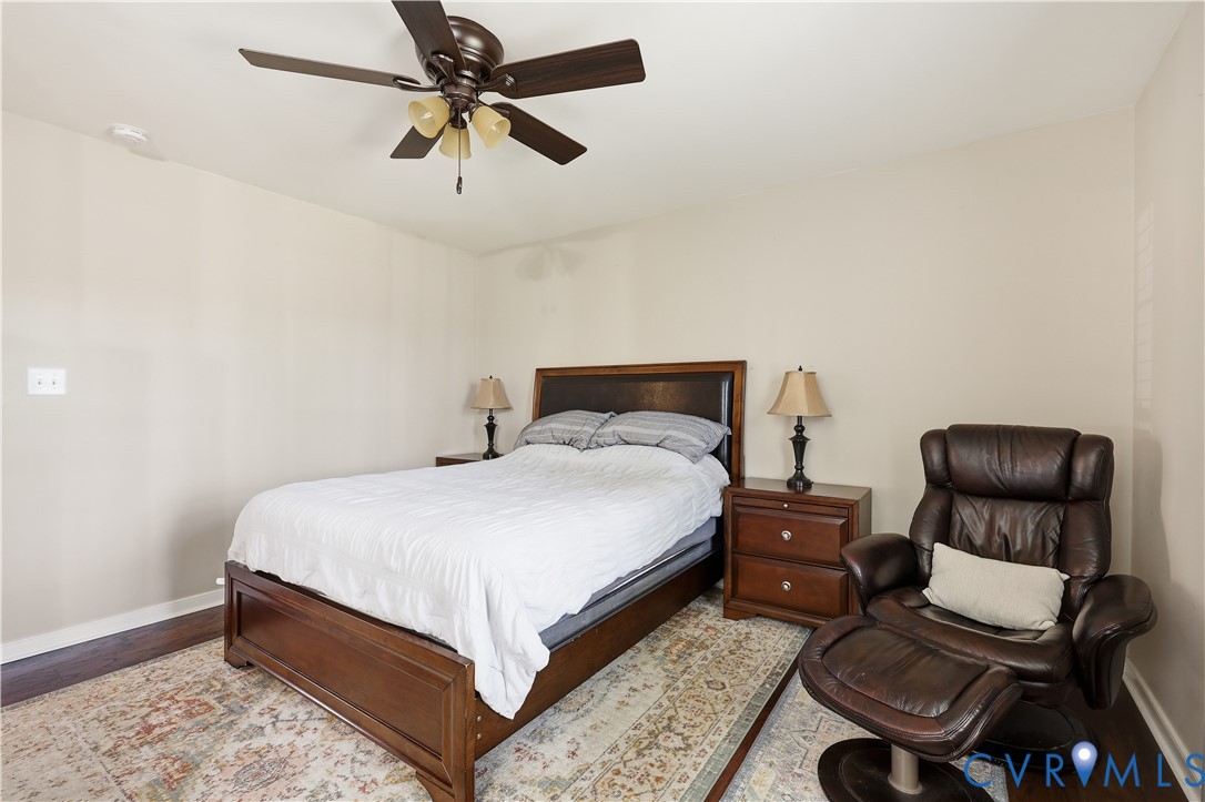 28820 Butler Branch Road Petersburg, VA 23805 - Photo 14 of 27 a bedroom with a bed and a chair