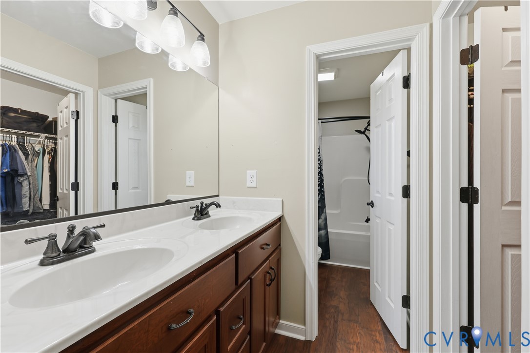 28820 Butler Branch Road Petersburg, VA 23805 - Photo 15 of 27 a bathroom with a sink double vanity and a mirror