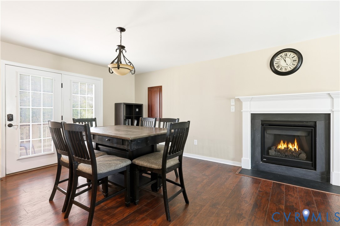 28820 Butler Branch Road Petersburg, VA 23805 - Photo 9 of 27 a view of a dining room with furniture wooden floor and a fireplace