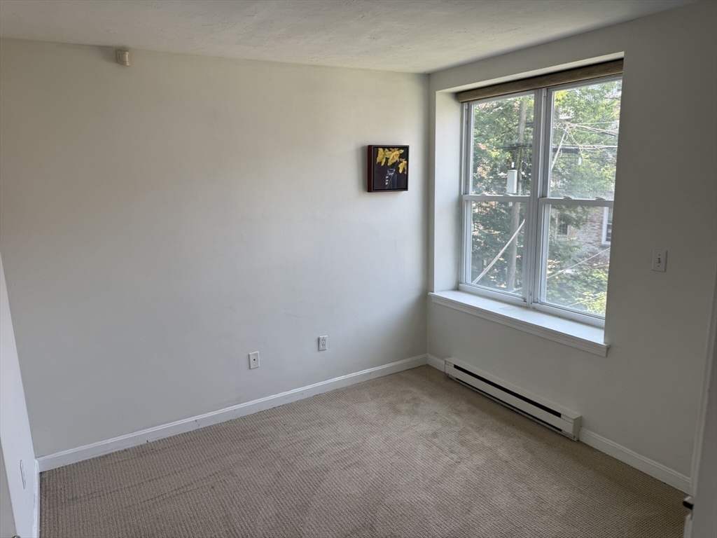 160 Cottage Street, Unit 2 Boston, MA 02128 - Photo 7 of 11 an empty room with a window