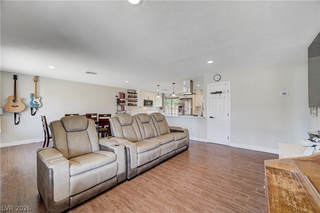 1331 Pinto Road Boulder City, NV 89005 - Photo 14 of 46 An open concept living area seamlessly connects to a kitchen with stainless steel appliances and a breakfast bar.