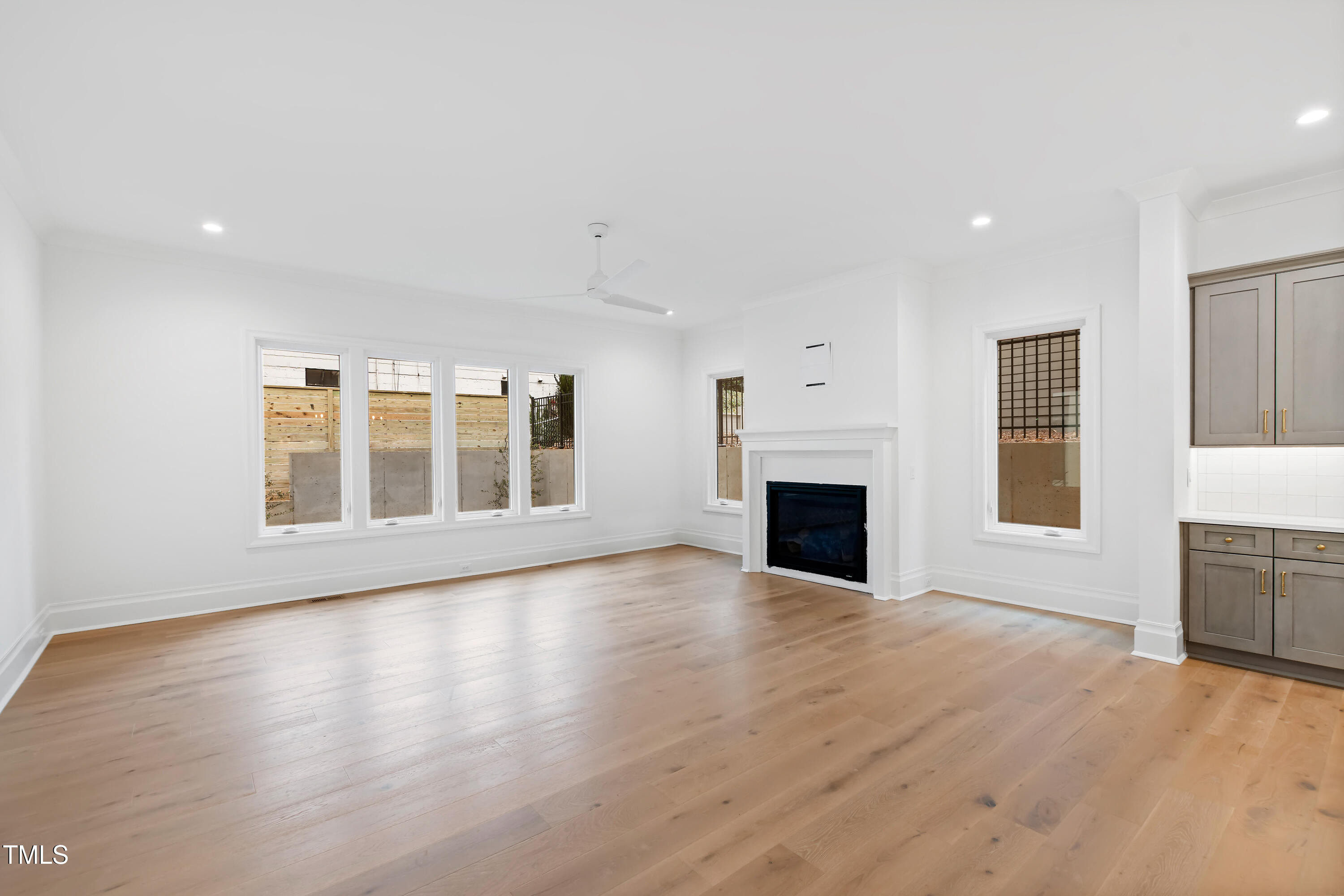 2419 Mayview Road Raleigh, NC 27607 - Photo 11 of 55 a view of an empty room with a fireplace and a window
