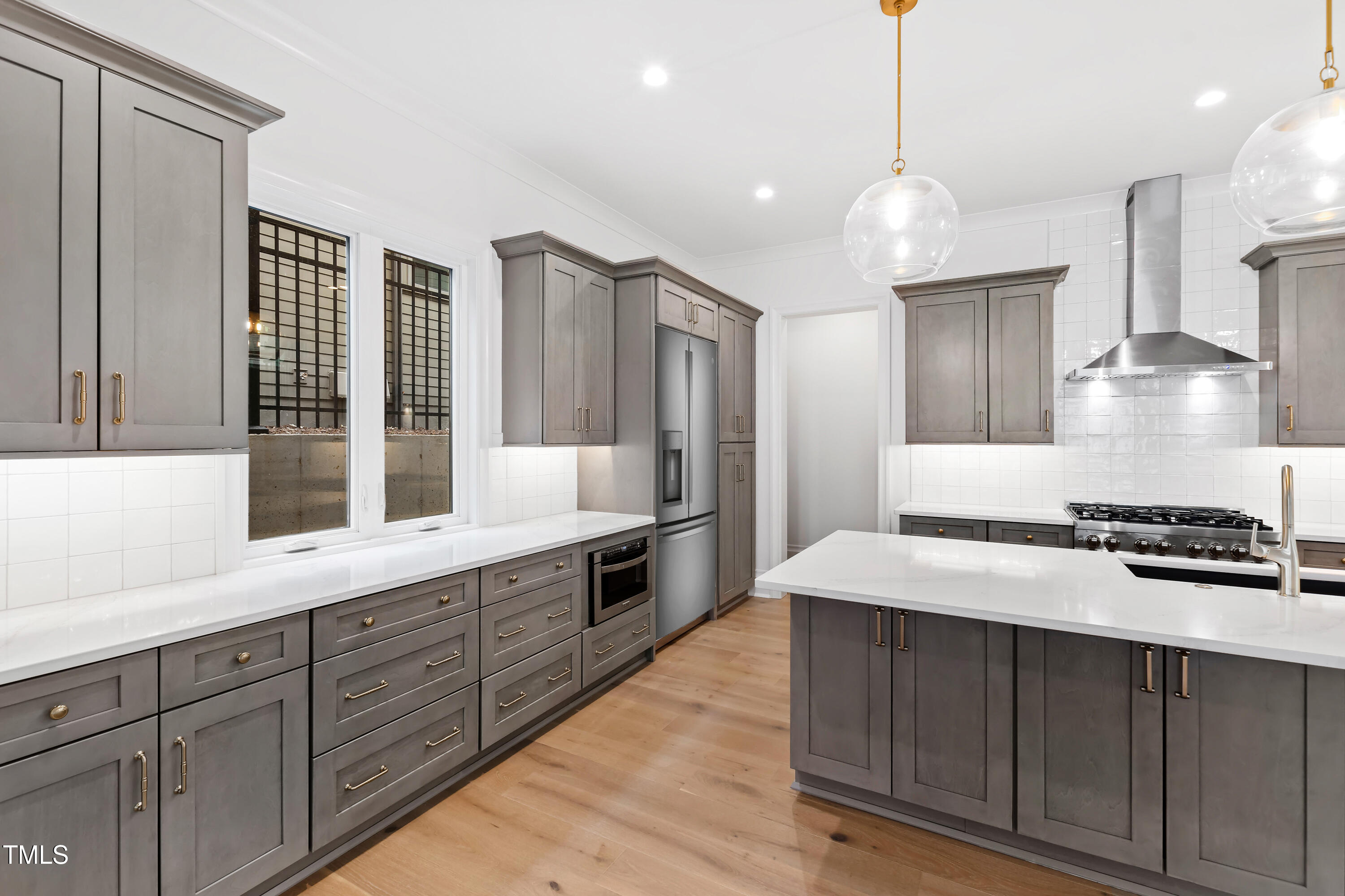 2419 Mayview Road Raleigh, NC 27607 - Photo 16 of 55 a kitchen with a stove a sink and a refrigerator