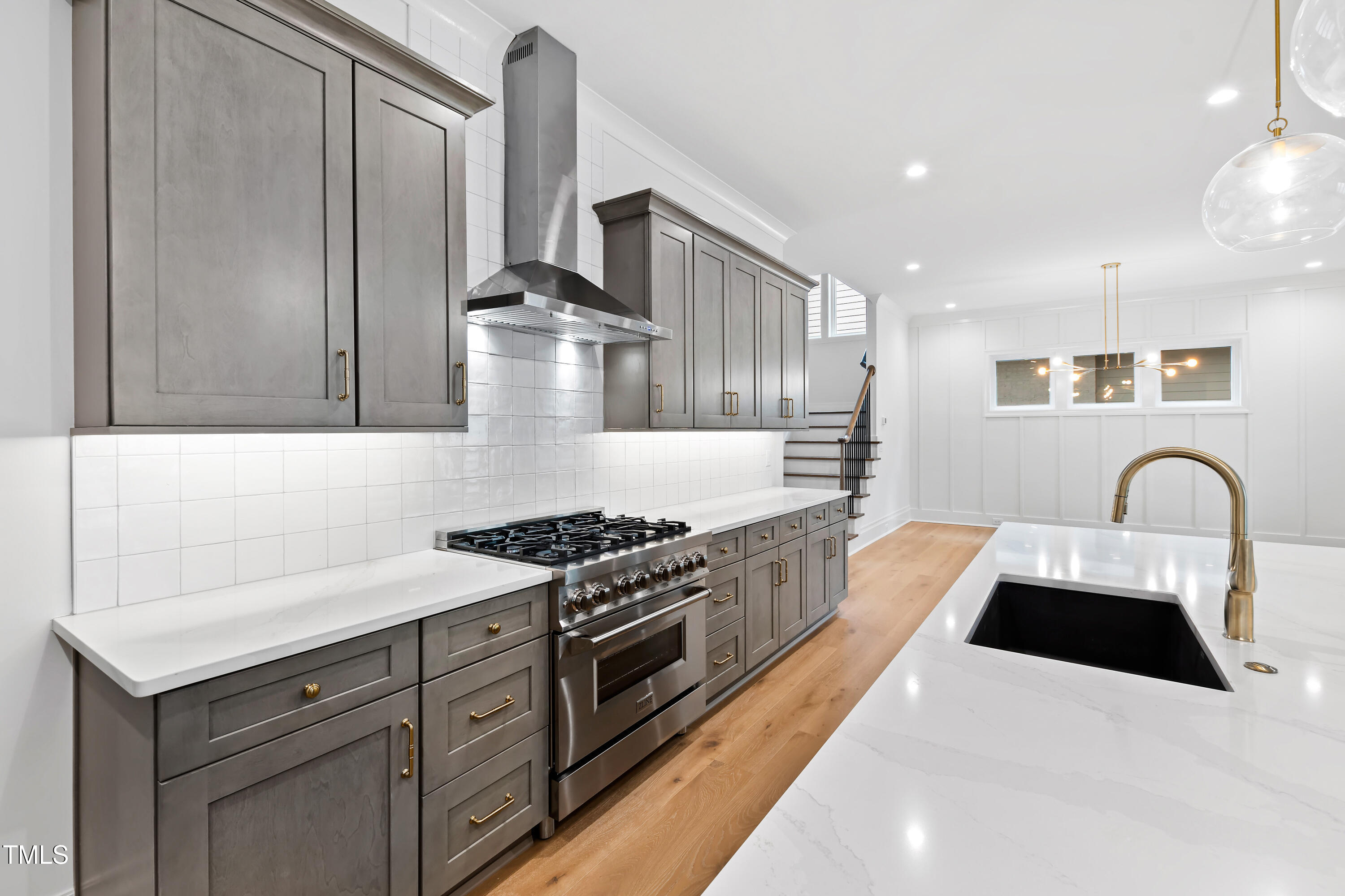 2419 Mayview Road Raleigh, NC 27607 - Photo 17 of 55 a kitchen with stainless steel appliances granite countertop a stove a sink and a granite counter tops with white cabinets
