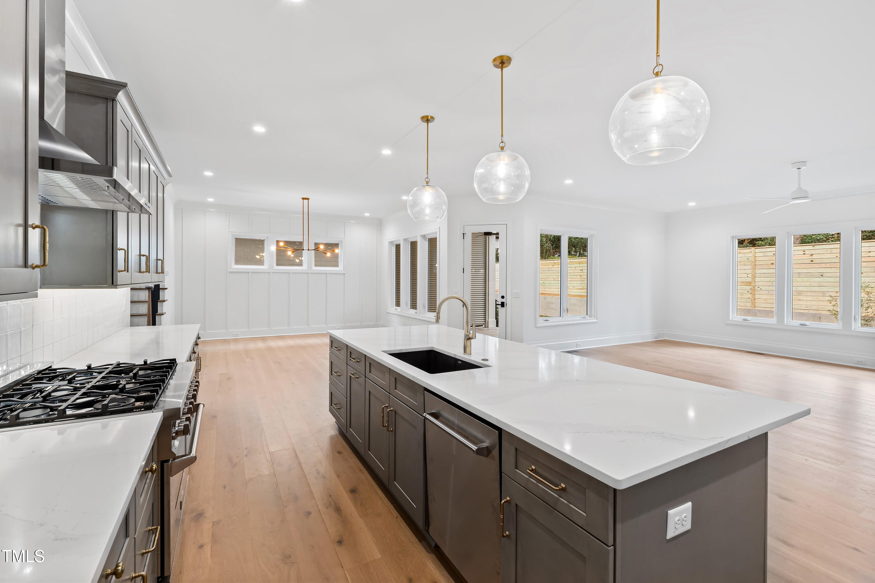 2419 Mayview Road Raleigh, NC 27607 - Photo 19 of 55 a kitchen with a sink stove and wooden floor