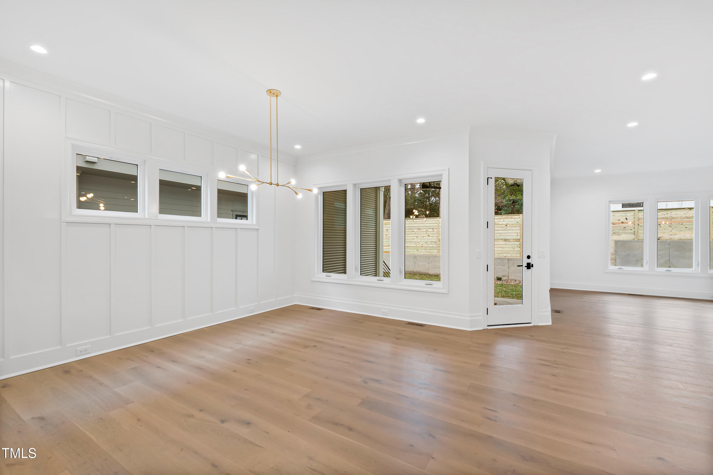 2419 Mayview Road Raleigh, NC 27607 - Photo 9 of 55 a view of an empty room with glass door and wooden floor