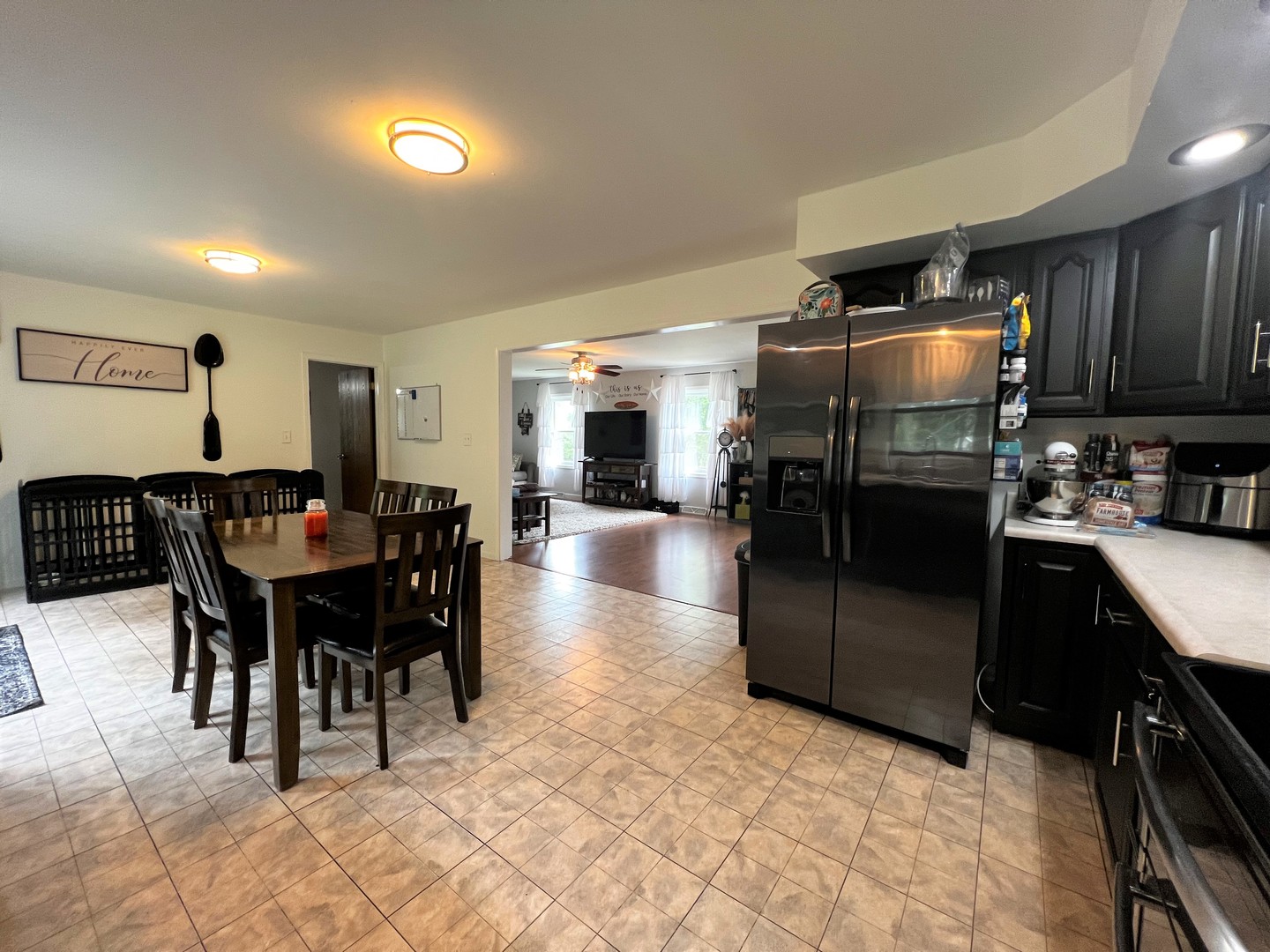 303 Minnesota Drive Dixon, IL 61021 - Photo 13 of 34 a kitchen with stainless steel appliances granite countertop a refrigerator a sink a stove a dining table and chairs
