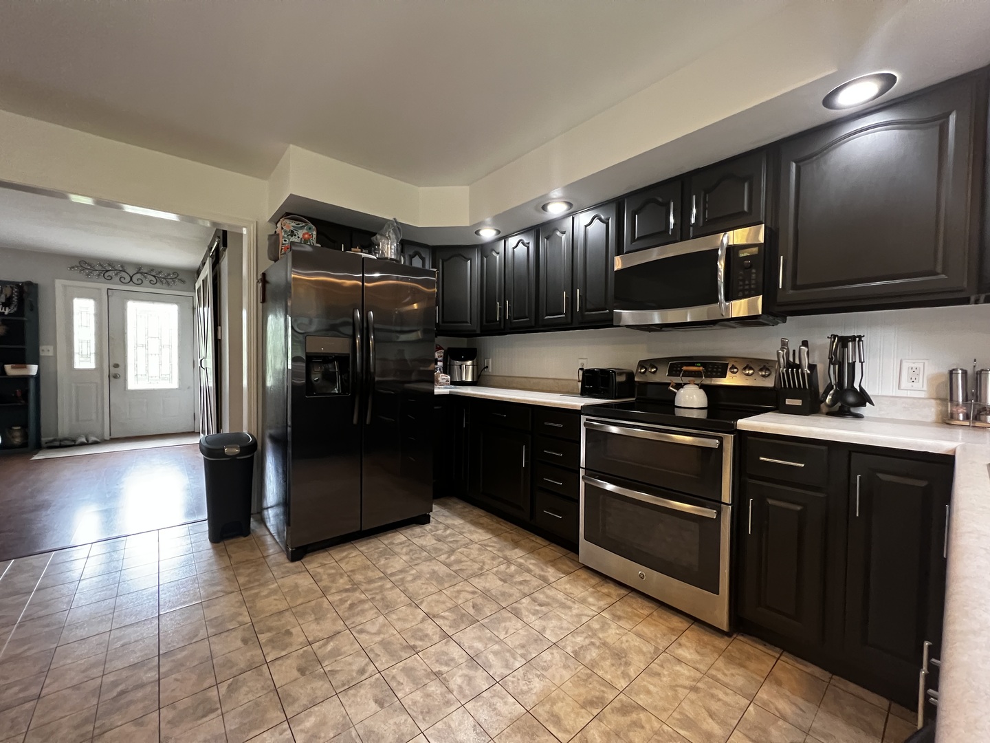 303 Minnesota Drive Dixon, IL 61021 - Photo 14 of 34 a kitchen with stainless steel appliances granite countertop a refrigerator and a stove top oven