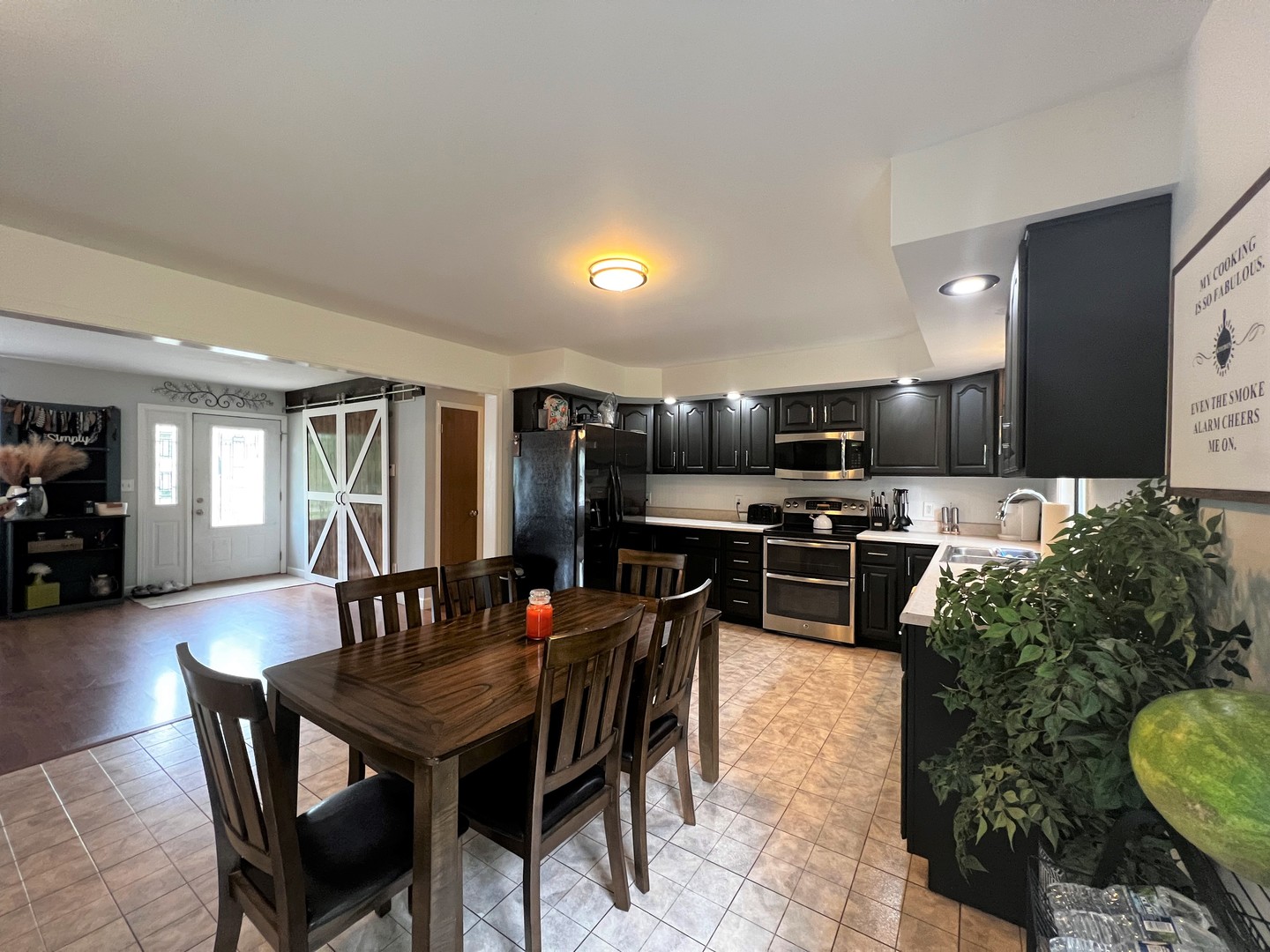 303 Minnesota Drive Dixon, IL 61021 - Photo 17 of 34 a kitchen with a table chairs stove and microwave