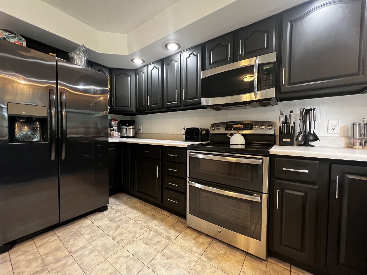 303 Minnesota Drive Dixon, IL 61021 - Photo 19 of 34 a kitchen with stainless steel appliances kitchen island granite countertop a refrigerator stove and microwave