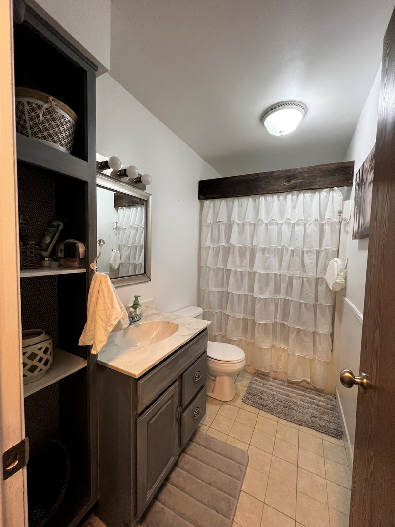 303 Minnesota Drive Dixon, IL 61021 - Photo 22 of 34 a bathroom with a sink toilet and shower