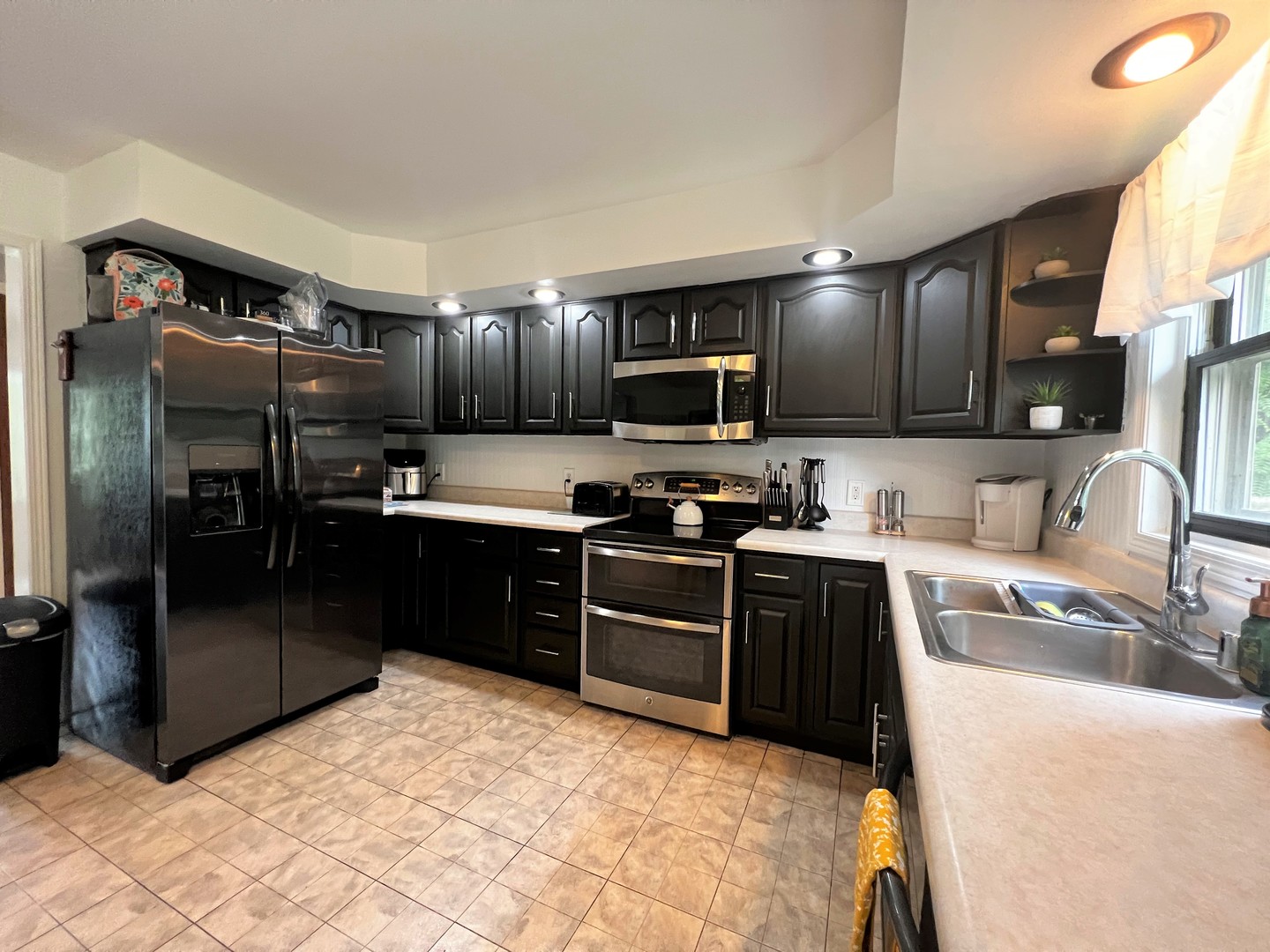 303 Minnesota Drive Dixon, IL 61021 - Photo 8 of 34 a kitchen with granite countertop a refrigerator and a stove top oven