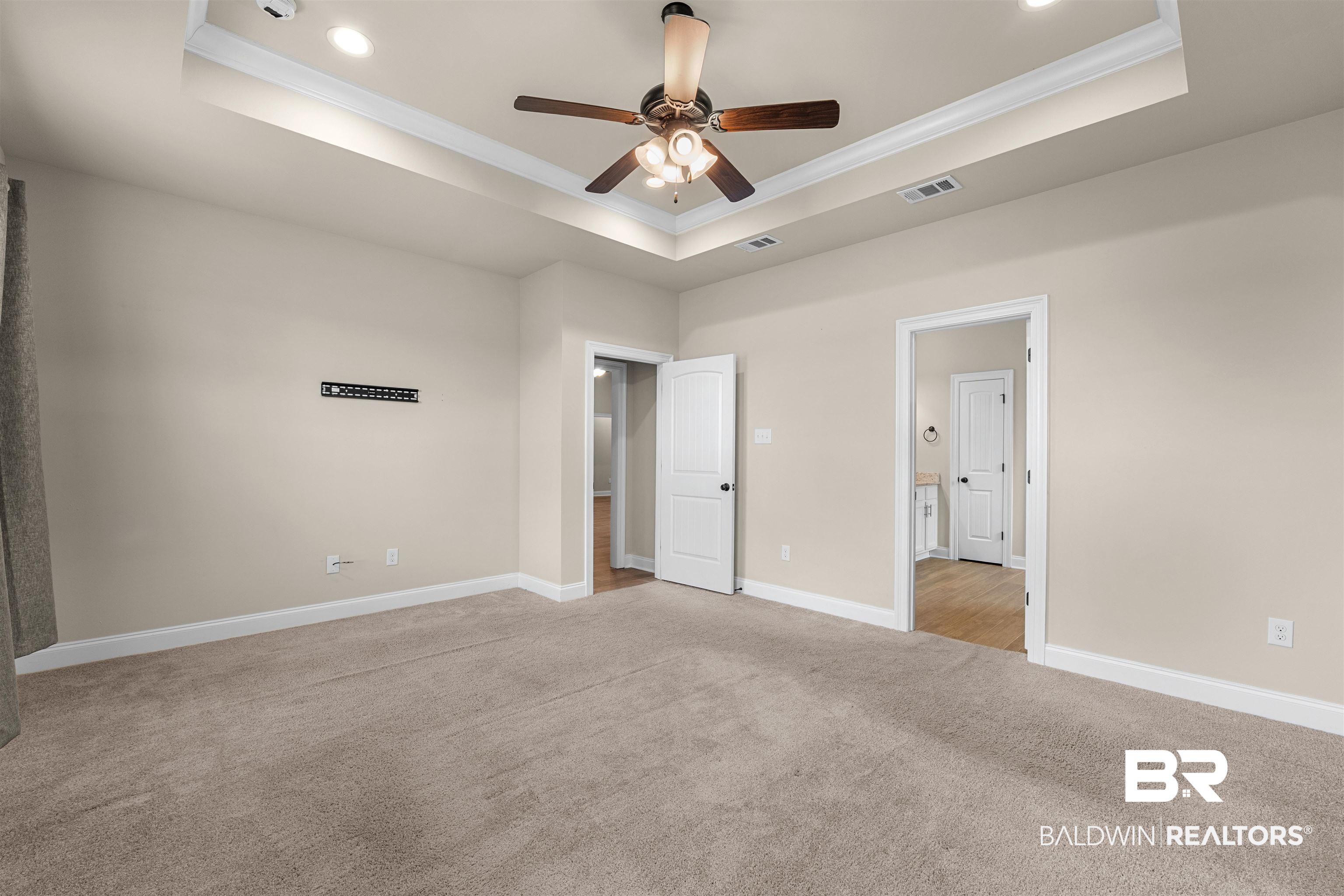 991 Dalton Circle Foley, AL 36535 - Photo 20 of 35 Unfurnished bedroom with a raised ceiling, light colored carpet, crown molding, recessed lighting, and ceiling fan