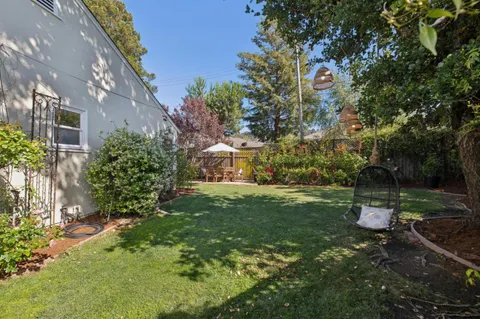 a backyard of a house with table and chairs