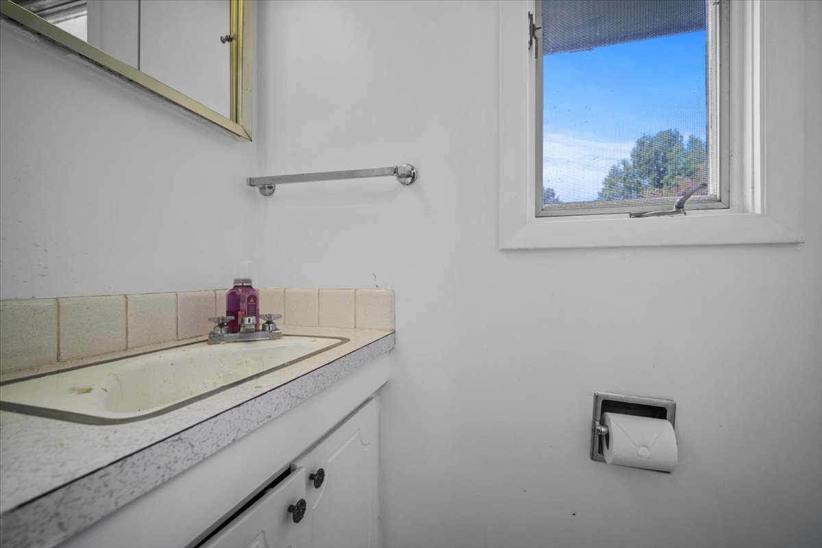 306 North Coolidge Street Normal, IL 61761 - Photo 20 of 32 a bathroom with a granite countertop sink and a window