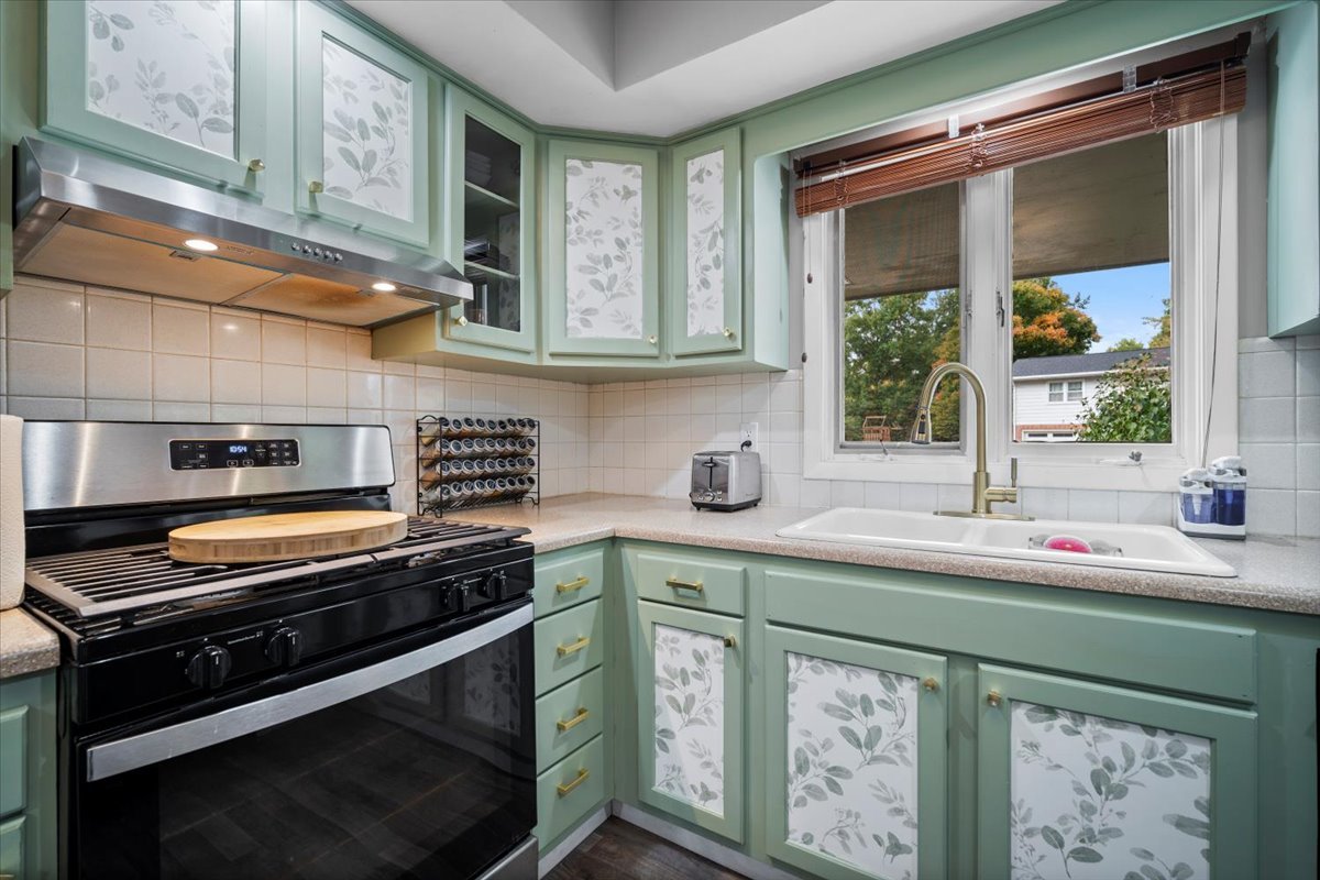 306 North Coolidge Street Normal, IL 61761 - Photo 21 of 32 a kitchen with stainless steel appliances a stove sink and cabinets