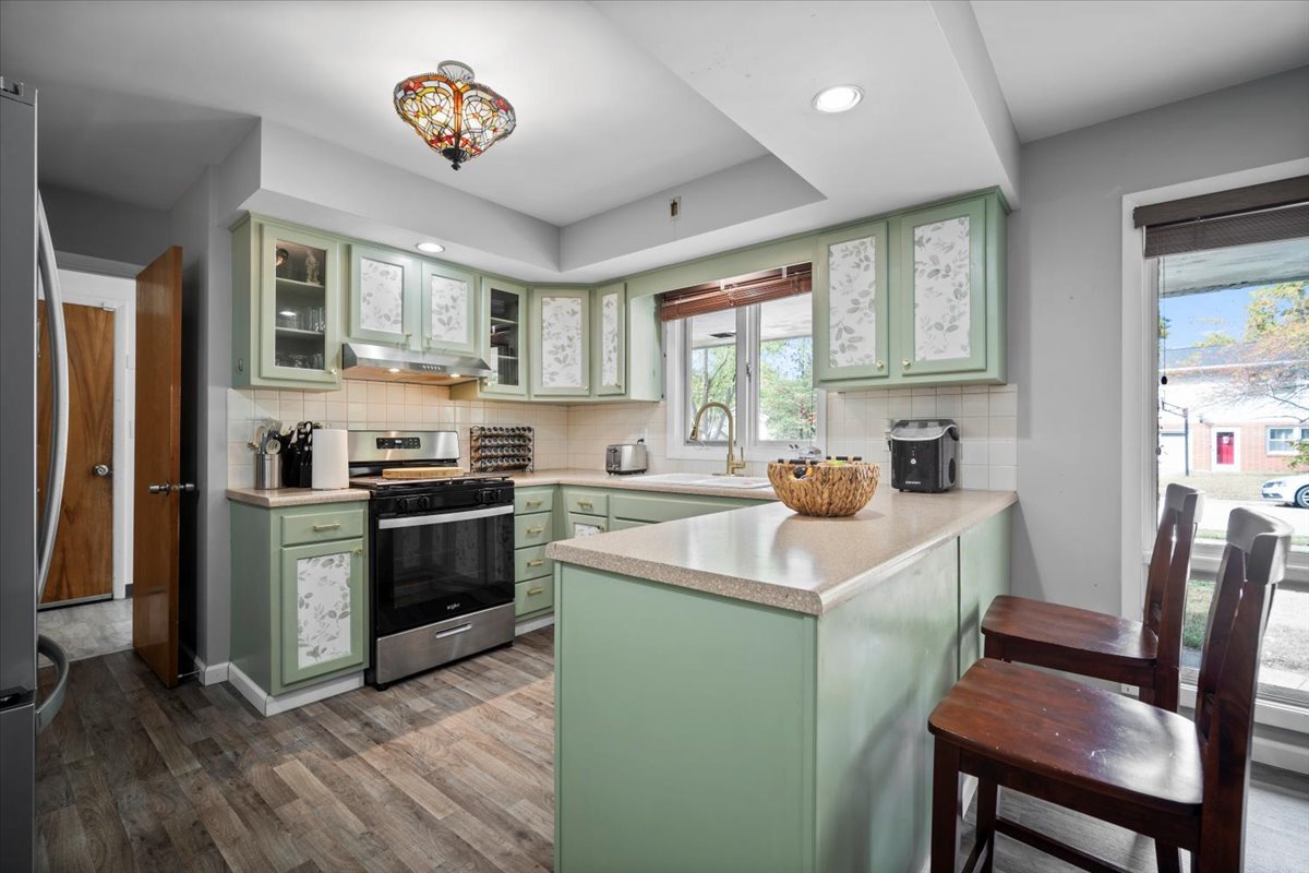 306 North Coolidge Street Normal, IL 61761 - Photo 4 of 32 a kitchen with a stove a sink and a refrigerator