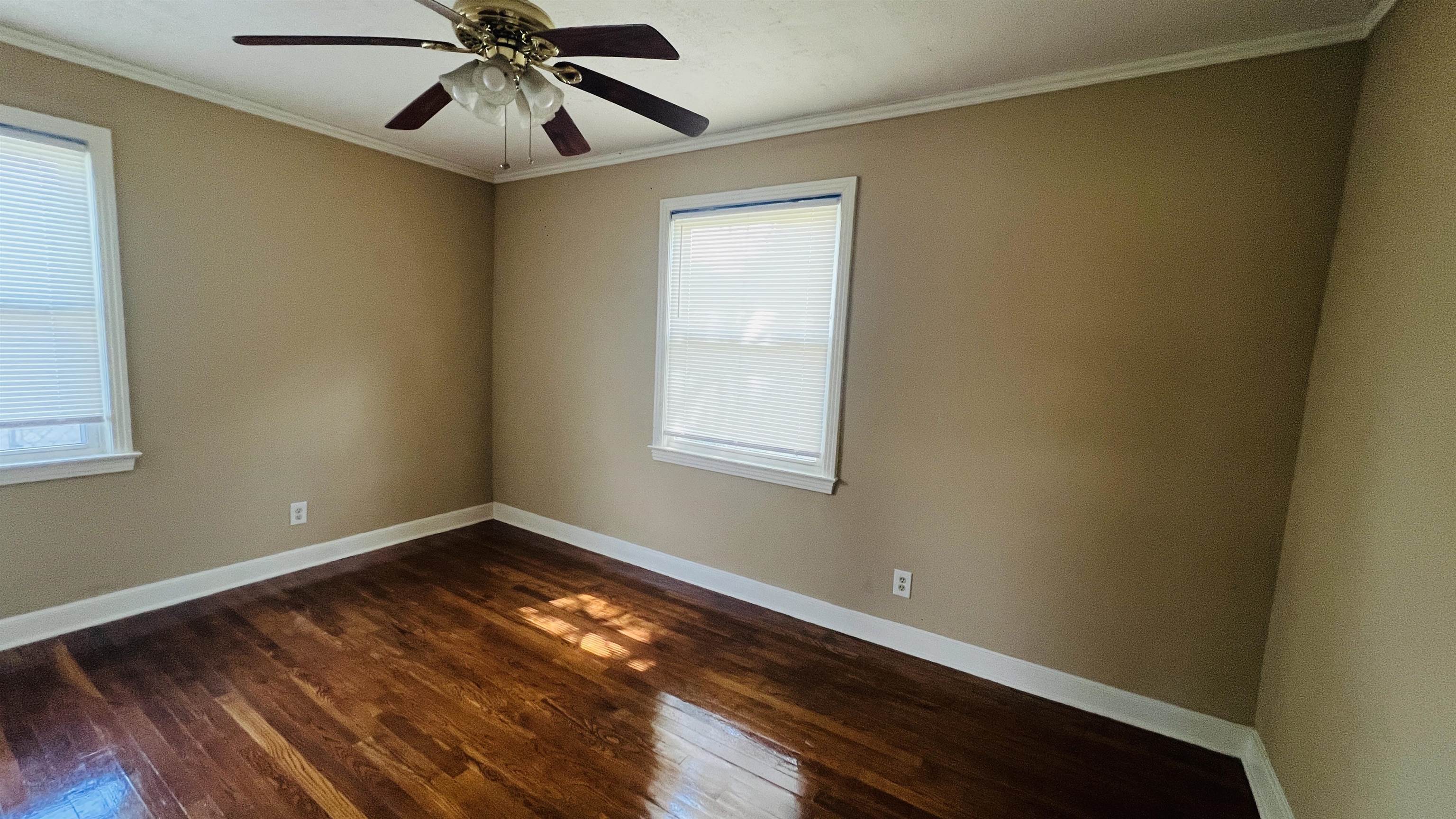4868 Southern Avenue Memphis, TN 38117 - Photo 11 of 15 a view of an empty room with wooden floor and a window