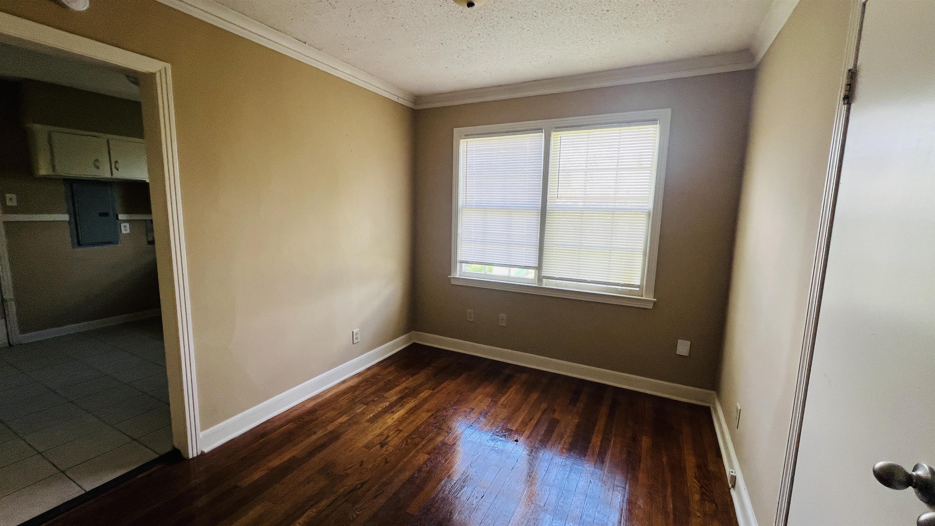 4868 Southern Avenue Memphis, TN 38117 - Photo 14 of 15 an empty room with wooden floor and windows