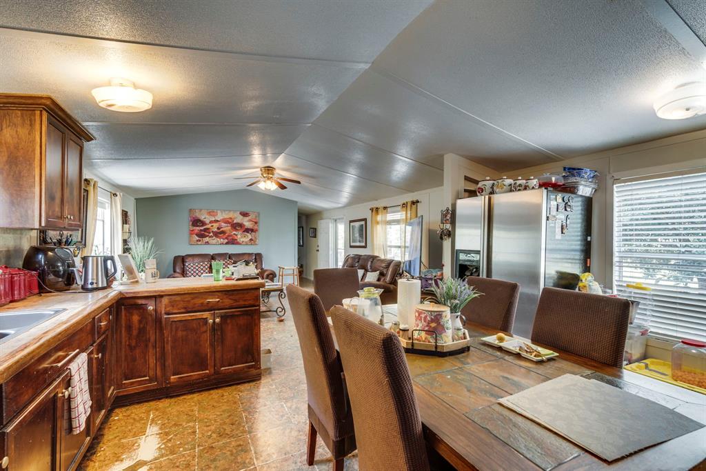 7251 Bennett Lawson Road Mansfield, TX 76063 - Photo 29 of 34 a view of a dining room with furniture a chandelier and wooden floor