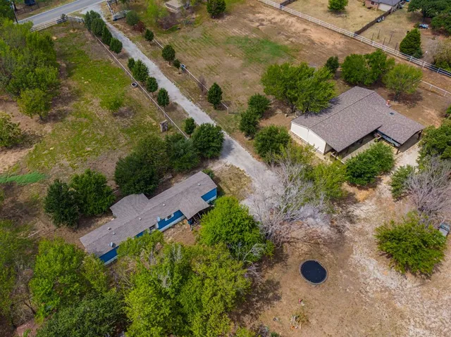 an aerial view of a house with yard and outdoor seating