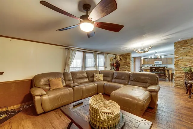 a living room with furniture gym equipment and a large window