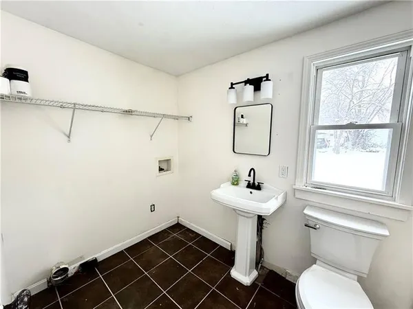 an empty room with wooden floor ceiling fan and windows