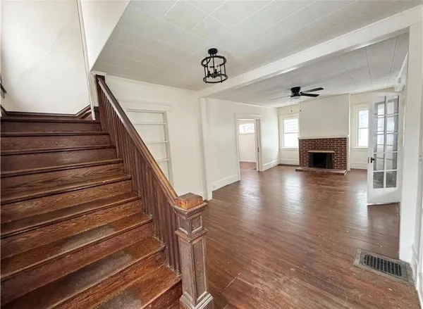 a view of entryway and hall with wooden floor