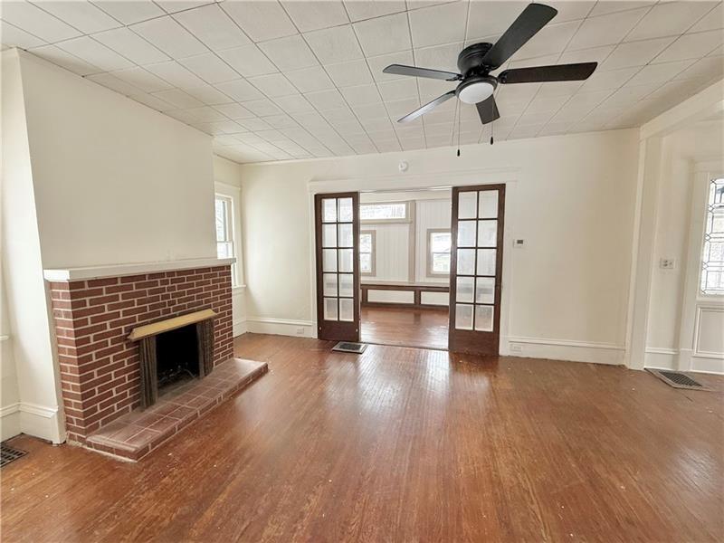 657 North Street Meadville, PA 16335 - Photo 9 of 24 wooden floor fireplace and windows in an empty room