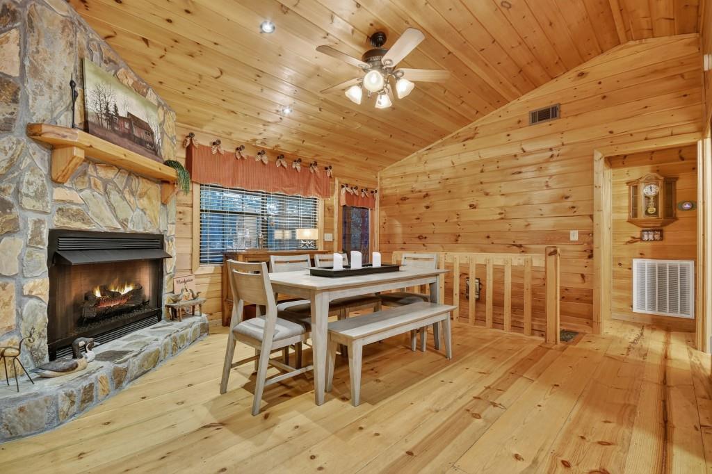 97 Doyle Carder Parkway Blue Ridge, GA 30513 - Photo 11 of 49 a living room with a fireplace a flat screen tv and outdoor seating