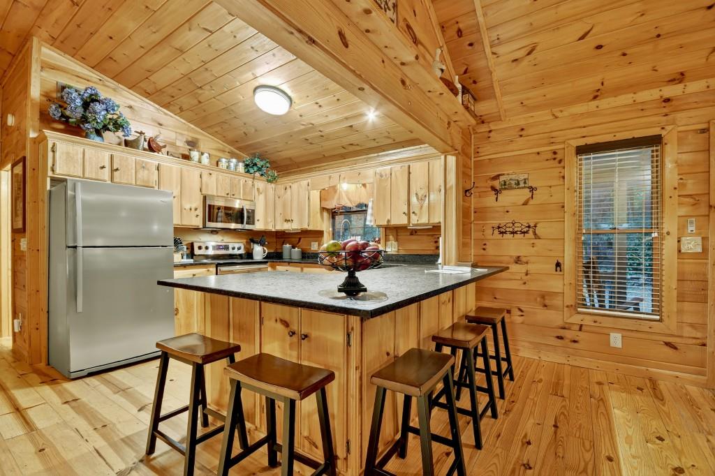 97 Doyle Carder Parkway Blue Ridge, GA 30513 - Photo 14 of 49 a kitchen with stainless steel appliances granite countertop a sink and a refrigerator