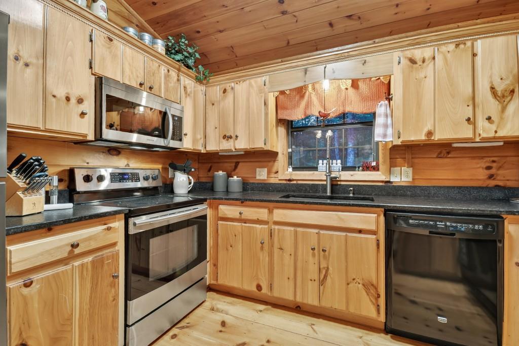97 Doyle Carder Parkway Blue Ridge, GA 30513 - Photo 15 of 49 a kitchen with stainless steel appliances granite countertop a stove a sink and a microwave