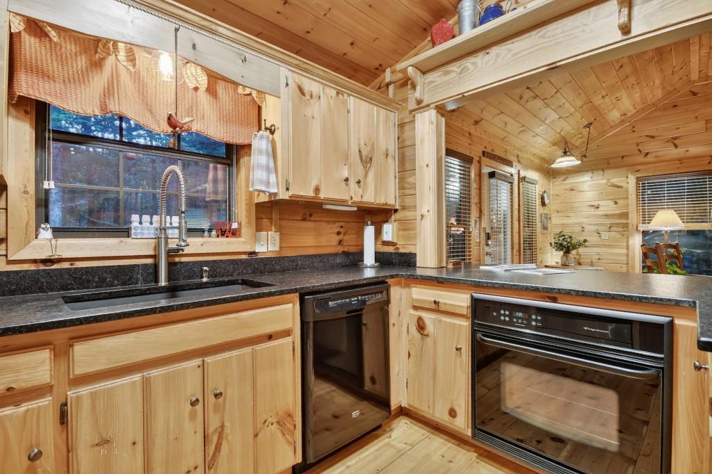 97 Doyle Carder Parkway Blue Ridge, GA 30513 - Photo 18 of 49 a kitchen with stainless steel appliances granite countertop a stove and a sink
