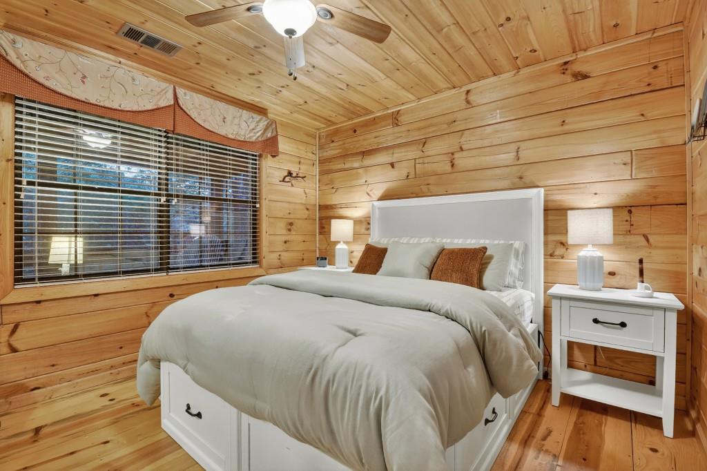 97 Doyle Carder Parkway Blue Ridge, GA 30513 - Photo 19 of 49 a bed sitting in a bedroom next to a window