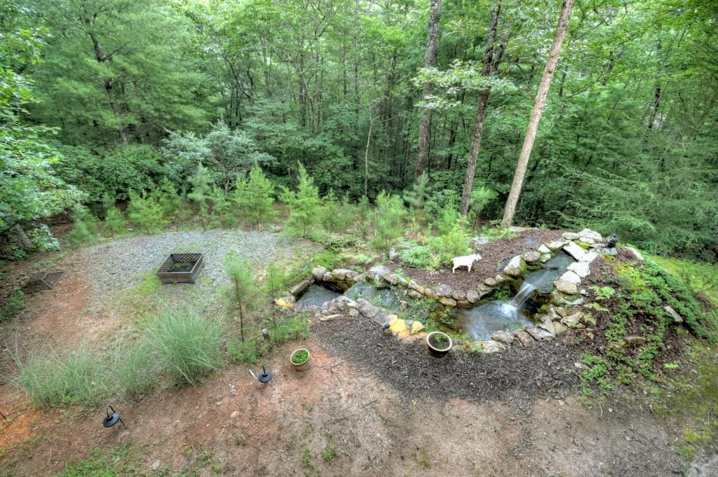 97 Doyle Carder Parkway Blue Ridge, GA 30513 - Photo 28 of 49 a view of a fire pit with large trees