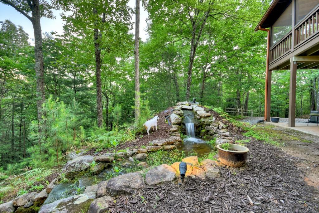 97 Doyle Carder Parkway Blue Ridge, GA 30513 - Photo 36 of 49 a view of a backyard with sitting area and garden