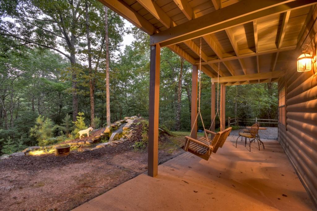 97 Doyle Carder Parkway Blue Ridge, GA 30513 - Photo 37 of 49 a view of a patio with a table chairs and a backyard