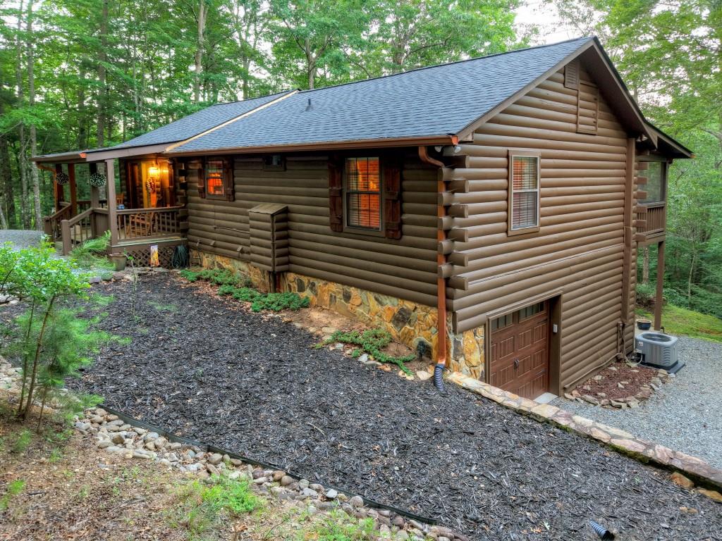 97 Doyle Carder Parkway Blue Ridge, GA 30513 - Photo 44 of 49 a front view of a house with garden