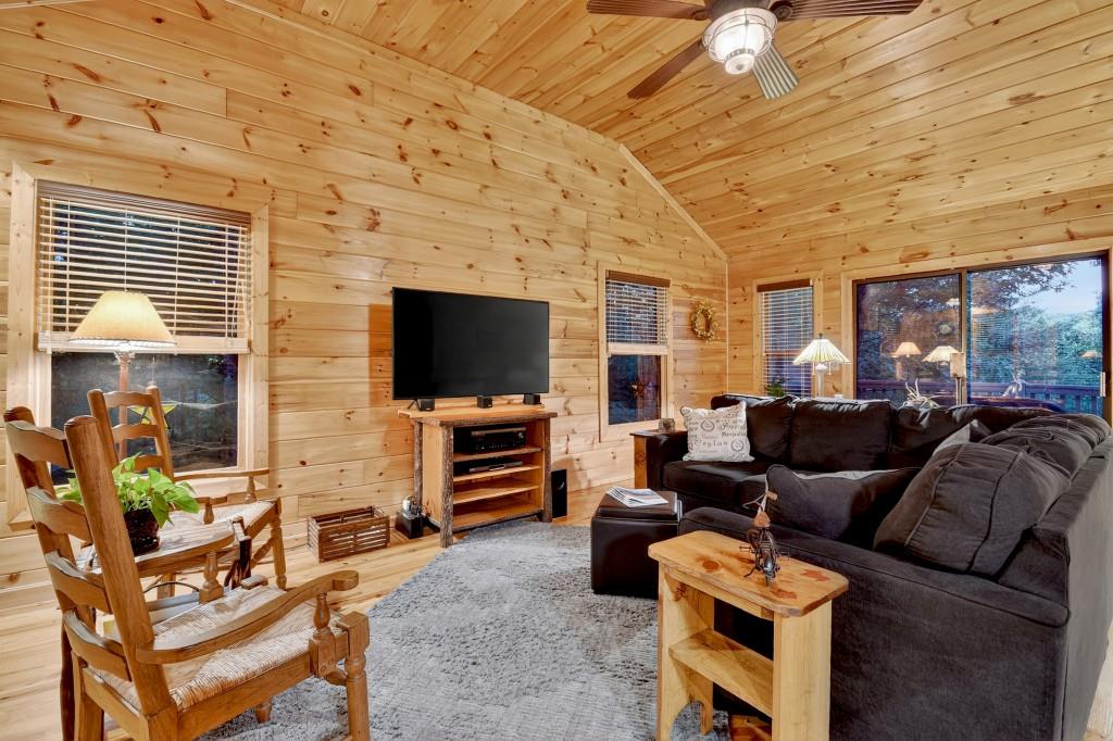 97 Doyle Carder Parkway Blue Ridge, GA 30513 - Photo 9 of 49 a living room with furniture a flat screen tv and a large window