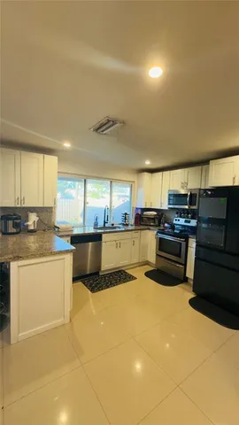 a kitchen with stainless steel appliances granite countertop a stove and a sink