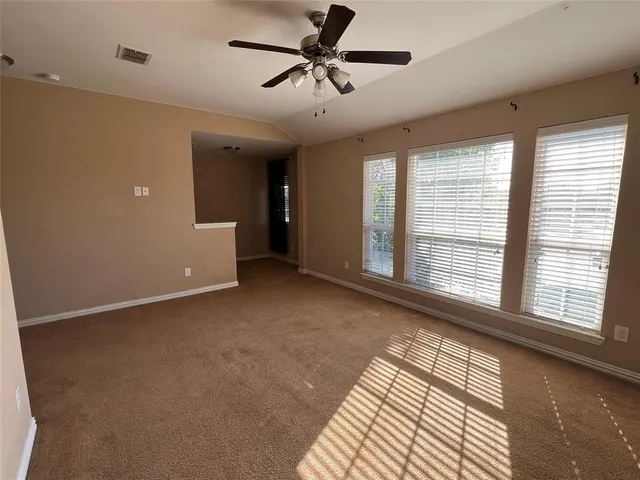 a view of a livingroom with a ceiling fan and window